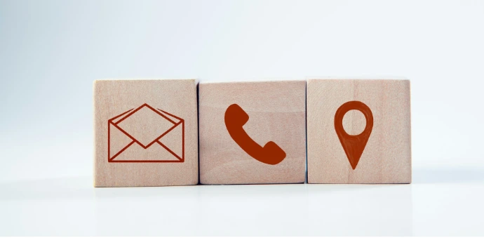 Wooden blocks with contact icons: envelope, phone, location
